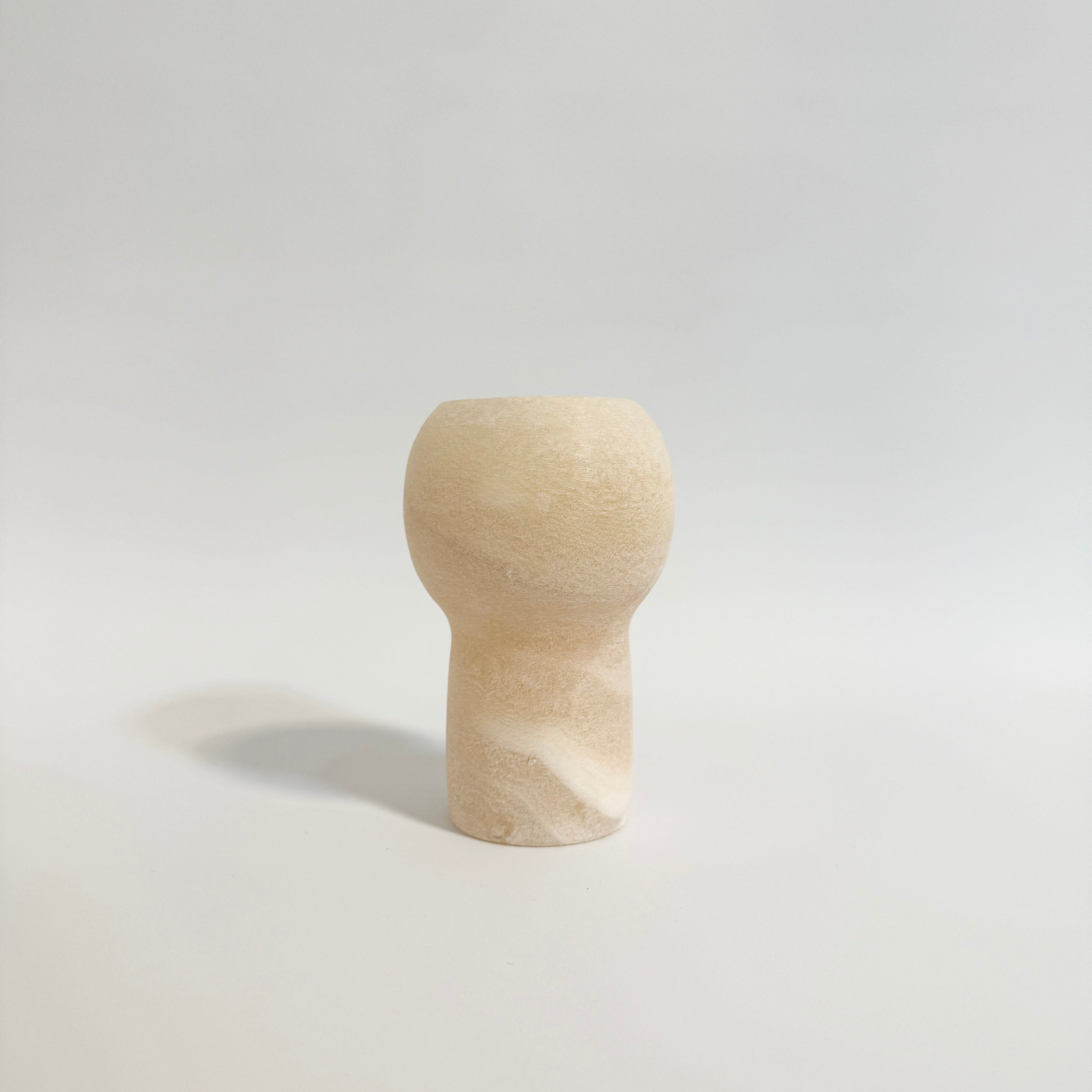 Minimalistisk alabast lysestage med naturlige farvespil og elegant finish.
