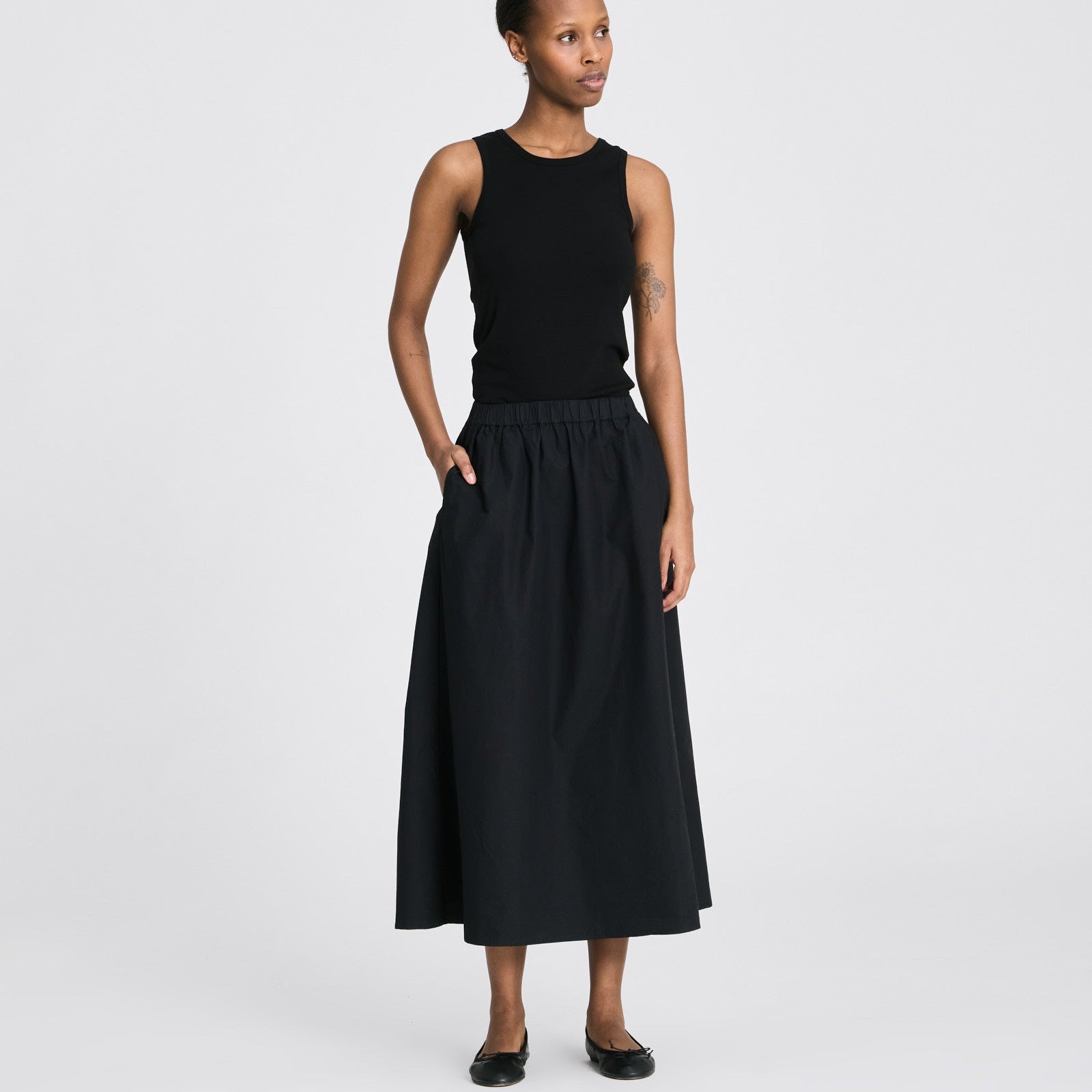 Alice Skirt i sort økologisk bomuldspoplin med elastisk talje og lang silhuet.