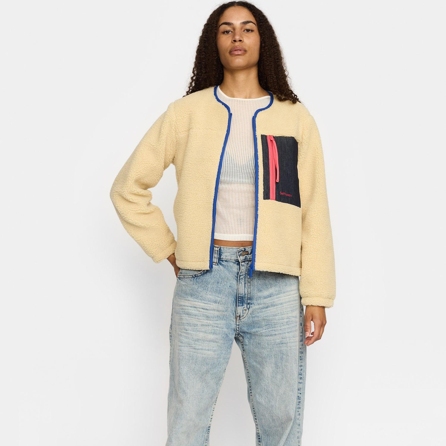 Offwhite teddyjakke fra Selfhood med en brun lomme på brystet