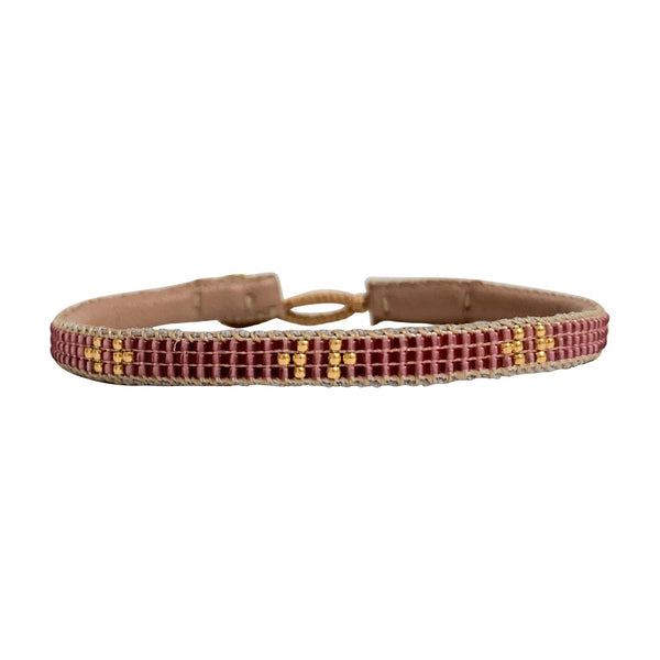 Ben armbåndet fra IBU jewels er en perlearmbånd i en mørk pink med guldperler på tværs af armbåndet