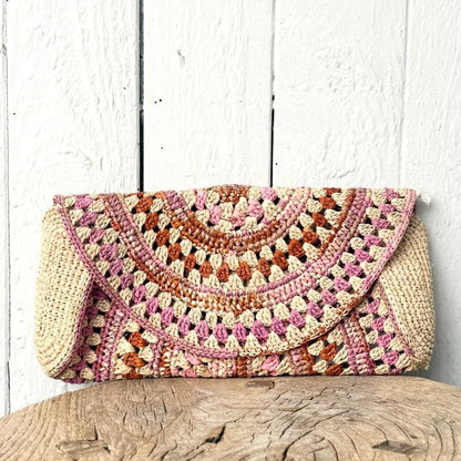 Legende clutch i raffia med flerfarvede detaljer – tilføjer personlighed og farve til ethvert outfit.