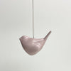 En keramik fugl lavet af Anne Black. Den er glaseret og i farven 'blush', som er en svag lyserød farve
