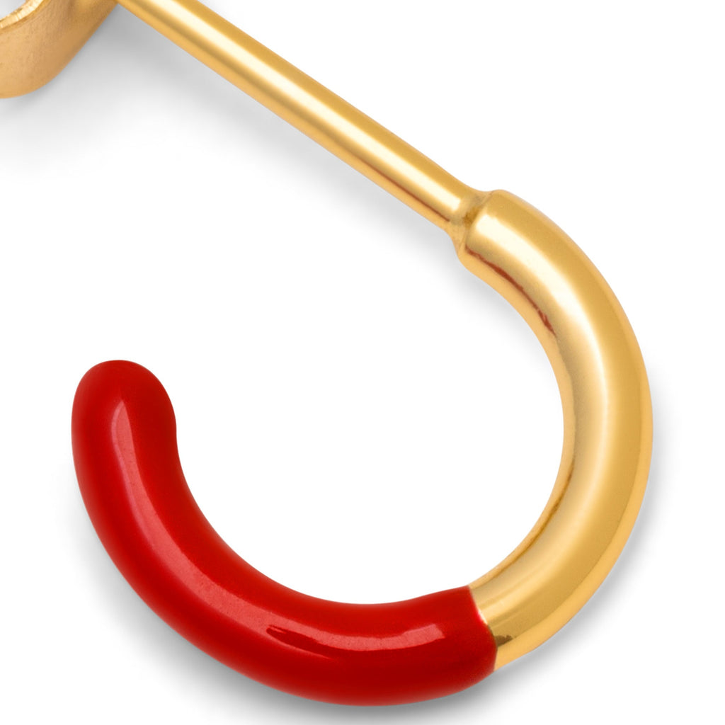 En lille hoop ørering fra Lulu Copenhagen som er guld, men halvdelen er dyppet i en rød farve
