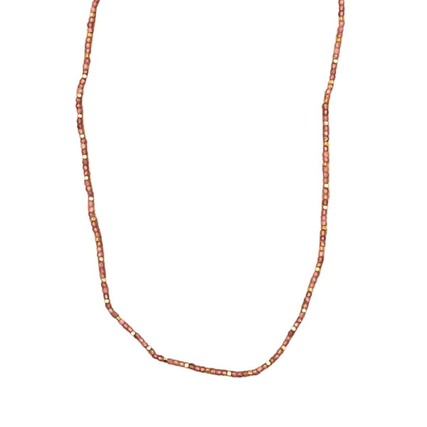 Stone Dot halskæden fra IBU Jewels er en tidløs halskæde. Modellen består af en farvet perle med en guldperle mellem hver anden til tredje farvet perle. 'Pink Tourmalin' er af en base af pink sten. 