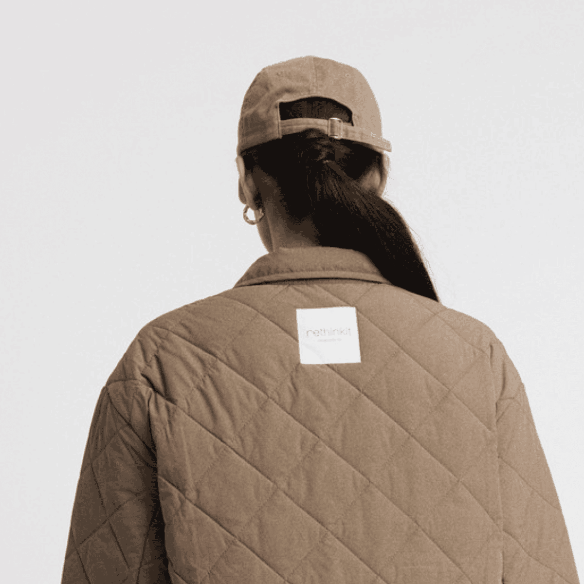 Brun cap i økologisk bomuld med justerbar lukning og diskret brunt broderi.