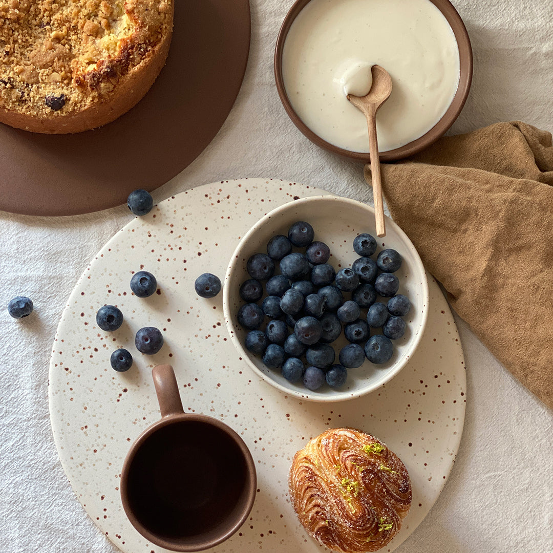 Den simple og minimalistiske Oktober fad er håndlaver af danske keramiker Julie Damhus. Det runde keramikfad måler 27,5 cm i diameter og er derfor perfekt som kagefad. Fadet har en mat glasur som giver stentøjet karakter. Den har en fin hvid farve med brune prikket. 