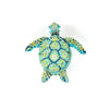 broche fra trovelore af en grøn/blålig skildpadde